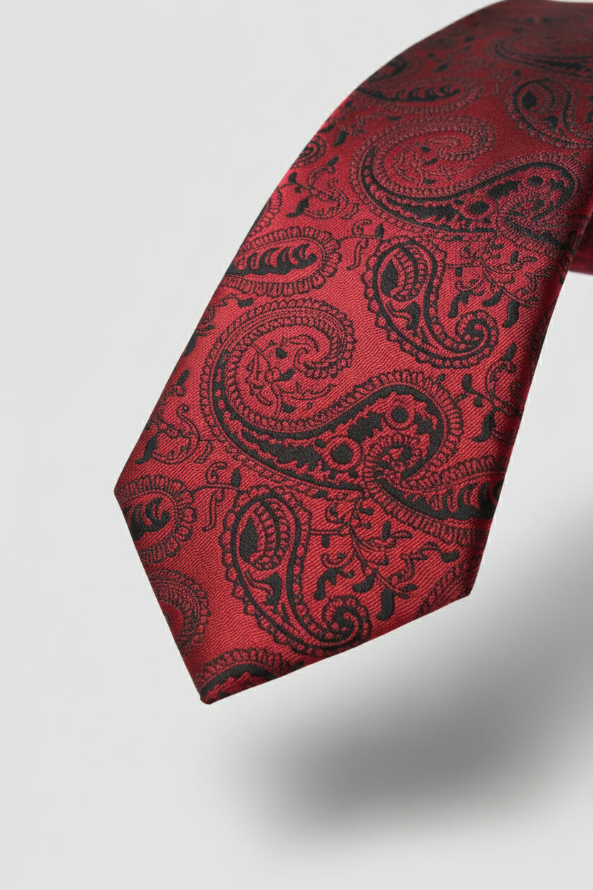 Red paisley silk tie featuring intricate black patterns, ideal for formal occasions.