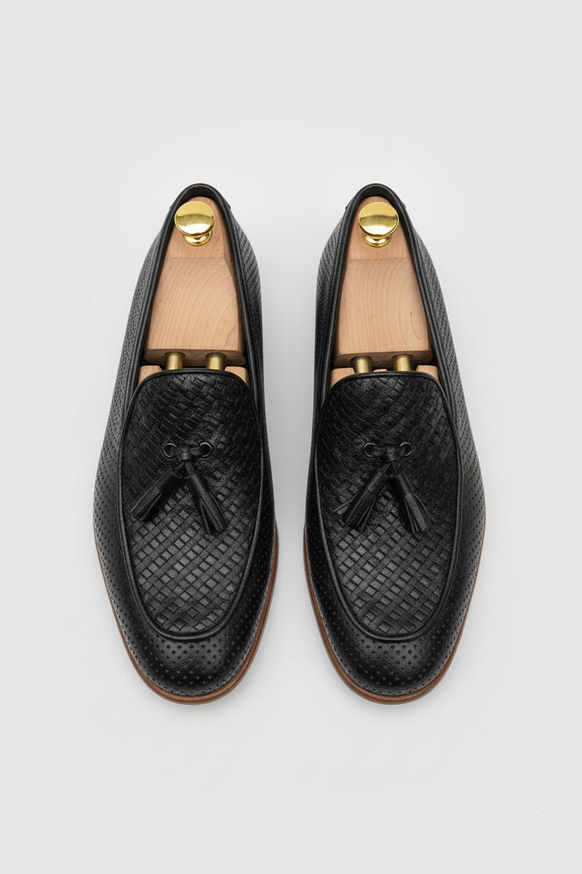 Black textured woven loafers with tassel detail, perfect for casual and formal wear.