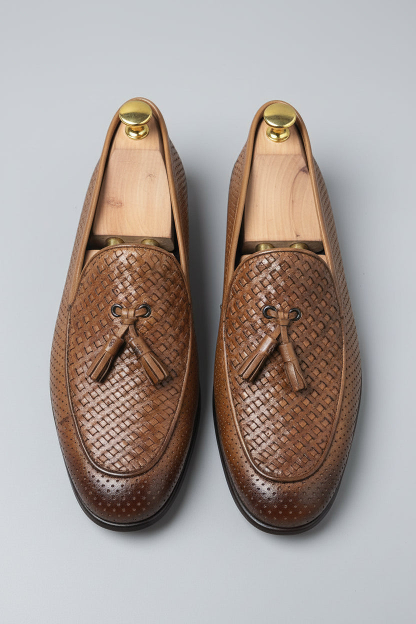 Brown woven leather loafers with tassels for stylish casual wear.