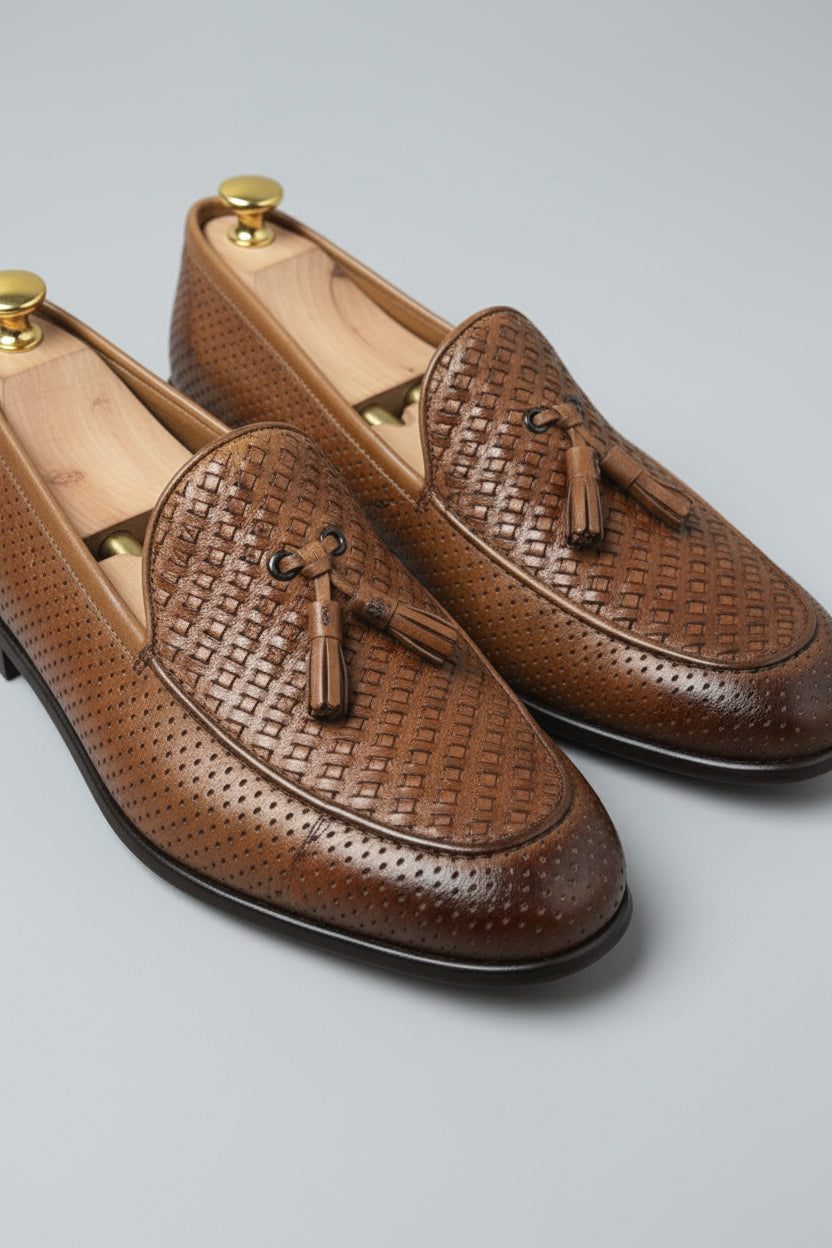 Brown woven leather loafers with tassels, perfect for casual and formal wear.