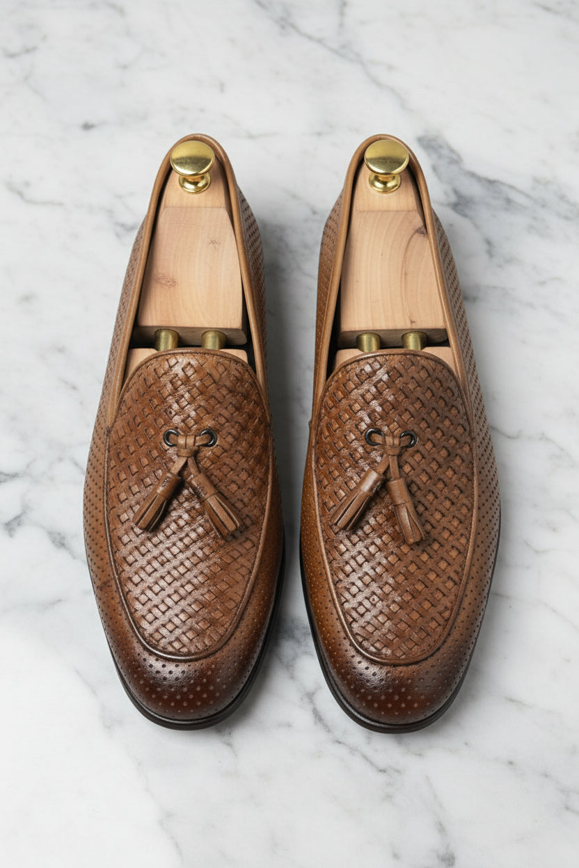 Brown woven leather loafers with tassels, ideal for casual and formal wear.