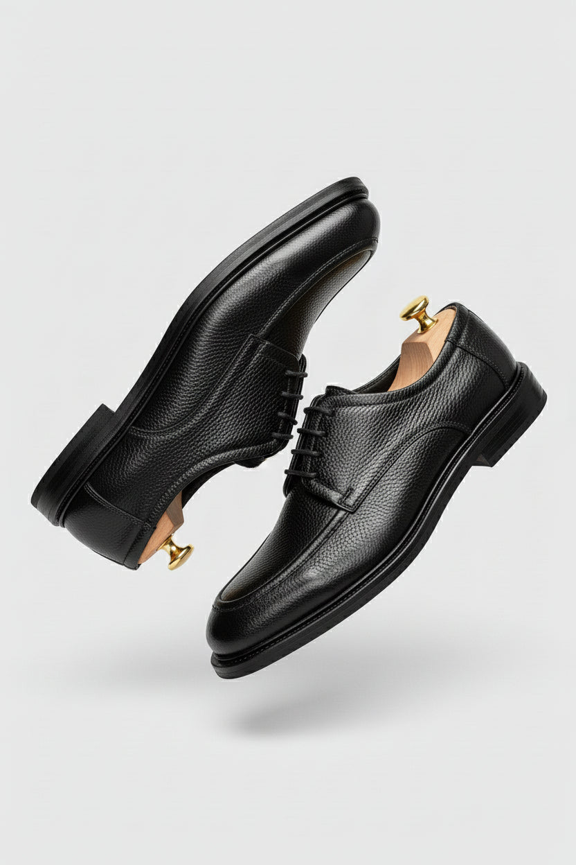 Black leather Oxford shoes with textured finish, ideal for formal wear and weddings.