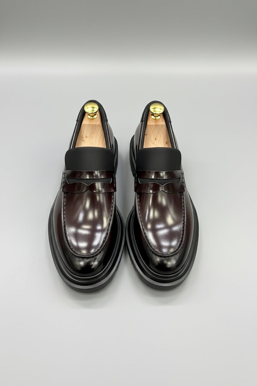 Burgundy leather slip-on loafers with sleek design and comfortable fit.