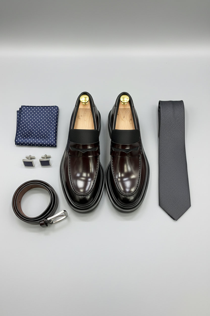 Burgundy leather slip-on loafers with elegant design, perfect for casual or semi-formal wear.