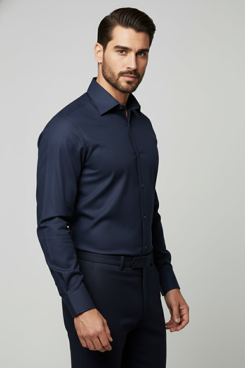 Man wearing navy slim fit striped dress shirt, styled for formal business wear.