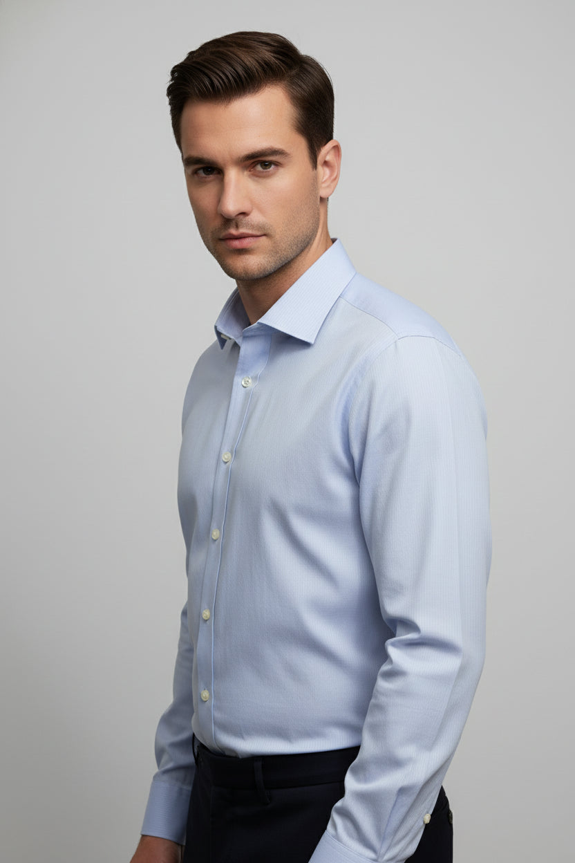 Man wearing light blue striped slim fit shirt with tailored fit for business attire.