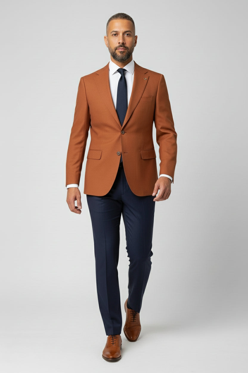 Man wearing orange and navy combination suit with peak lapels and tailored fit.